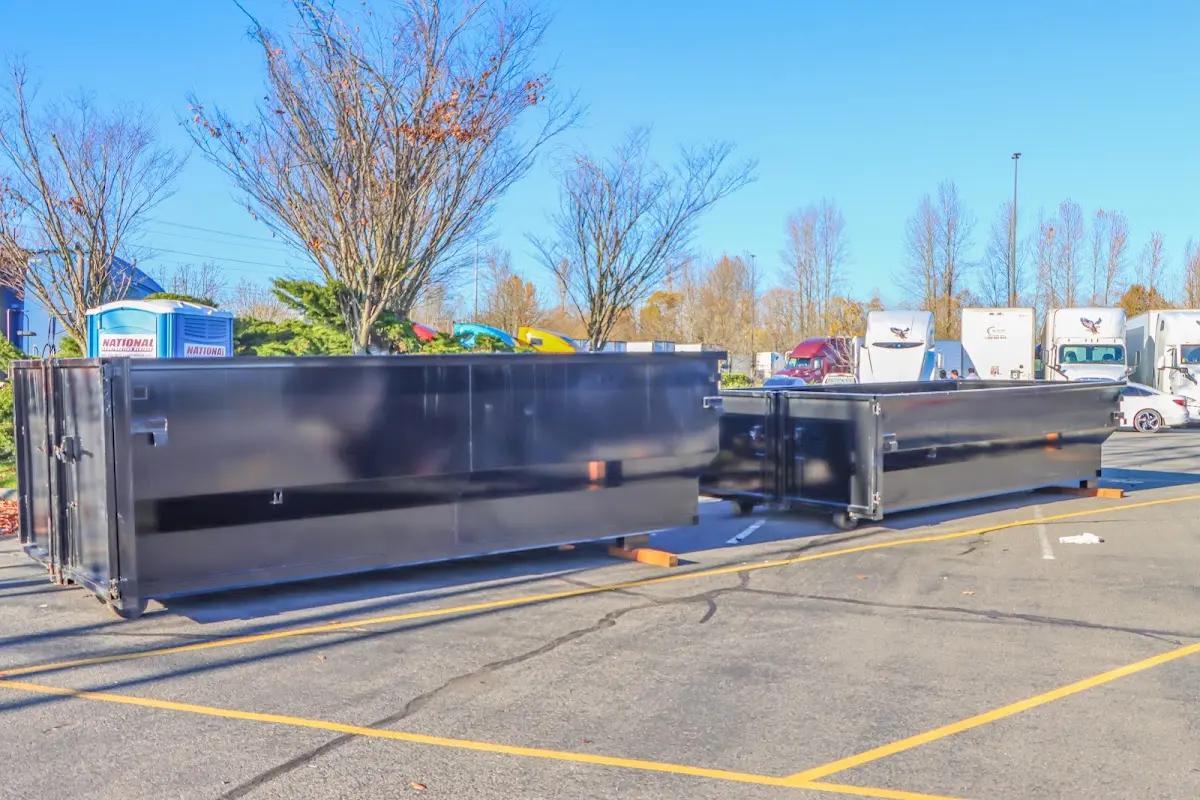 Professional dumpster rental service with roll-off container on residential driveway in Rodeo